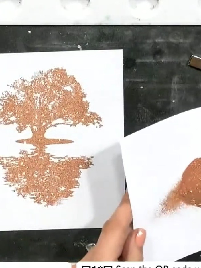 Step 5: Apply rose gold sparkle ink to the embossed tree stamp using a brush or applicator. Heat set the ink quickly w