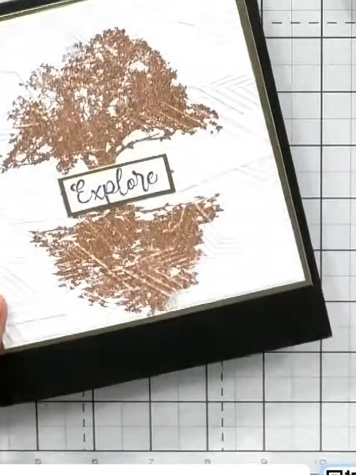 Step 6: Mount the finished stamped and embossed piece onto a black card blank using adhesive. Ensure the framed design