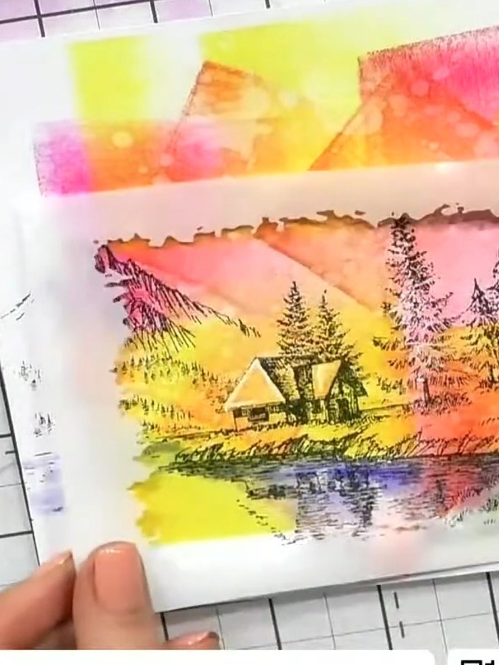 Step 1: Stamp the cabin scene from the Reflection stamp set onto your coloured background card using black ink. Positi