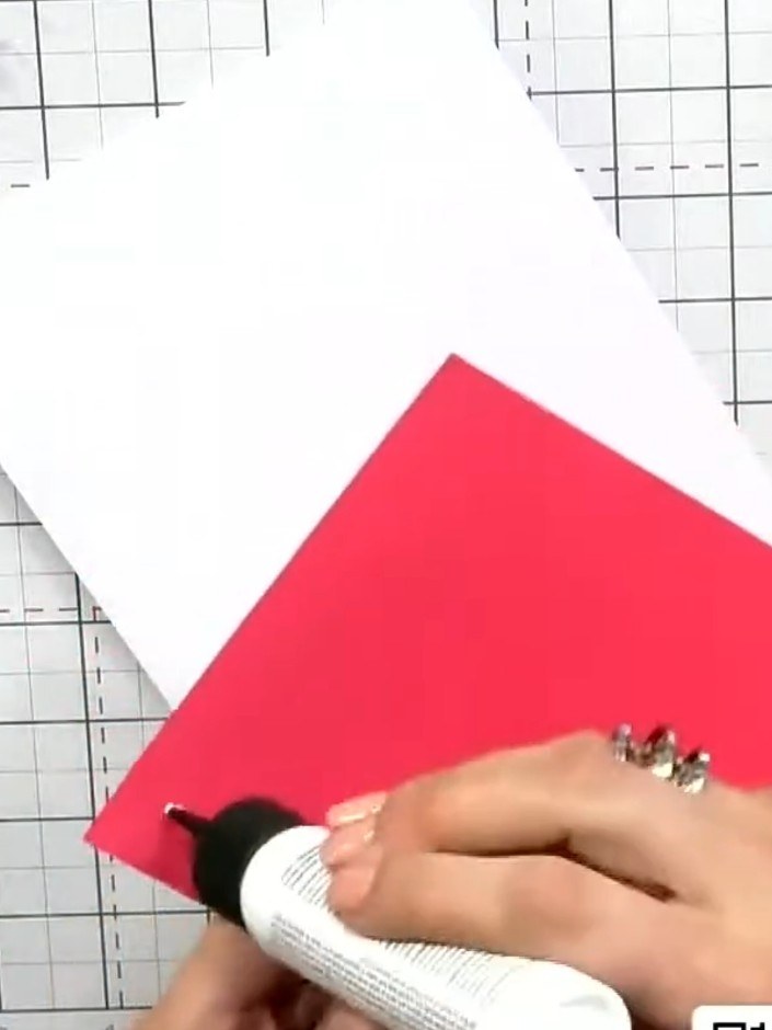 Step 10: Adhere the red cardstock panel to the white card base using adhesive. Position your completed watercolour pane
