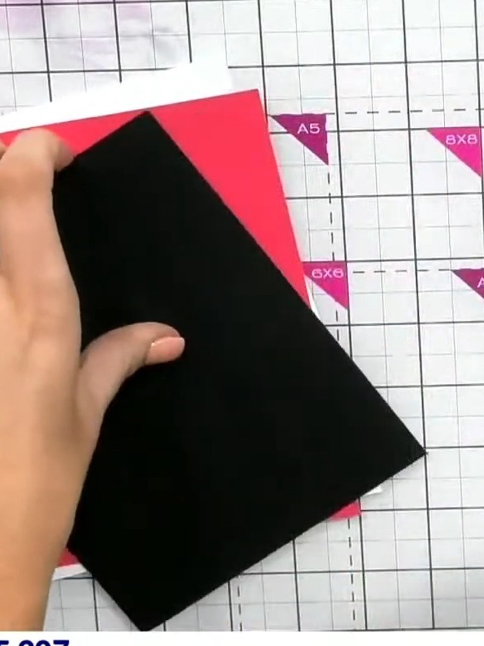 Step 9: Mount the finished painted panel onto a red card base using glue. Position the black panel with the watercolou