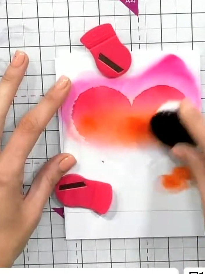 Step 3: Blend orange ink into the middle section of the heart using a blending brush, overlapping with the pink to cre
