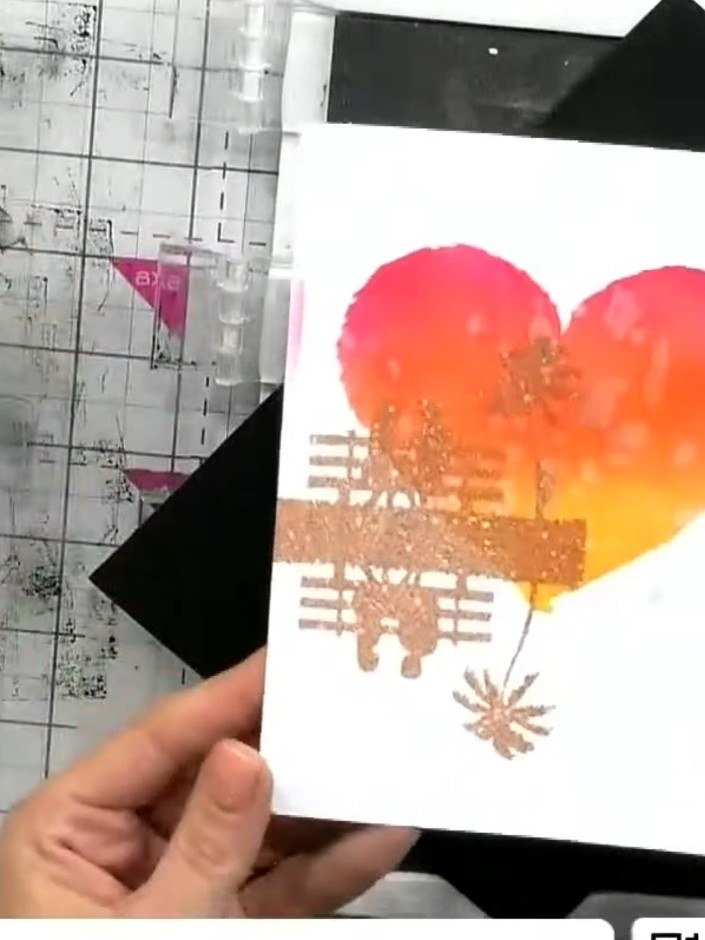 Step 9: Heat set the embossing powder with a heat gun, moving it over the design until the powder melts and becomes sh