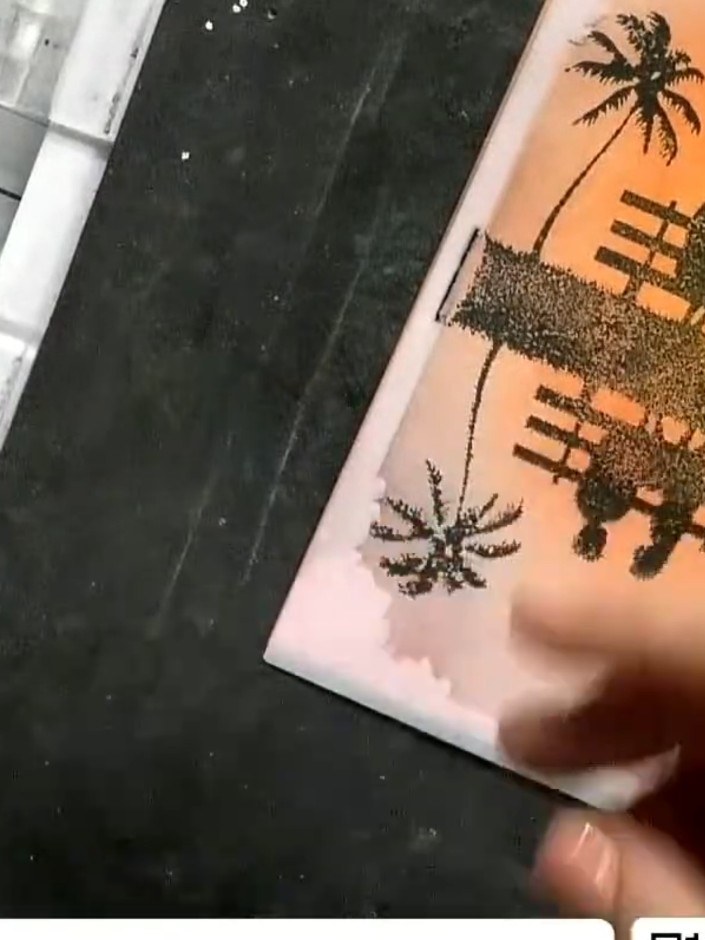 Step 5: Stamp the reflection tree design below the couple silhouette to create a water reflection effect. Position the
