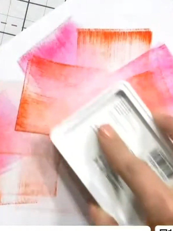 Step 2: Lift excess ink with a damp towel to create a bleached, softer effect. Allow the pink and orange colours to bl