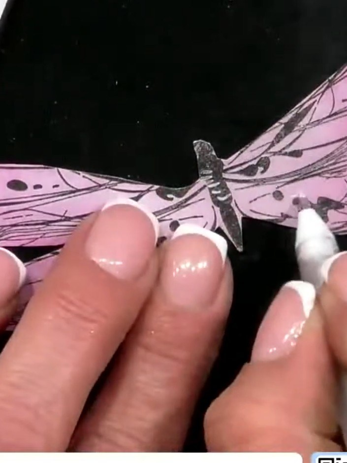 Step 6: Use a white gel pen to accentuate details on the dragonfly wings by tracing out the little details and adding 