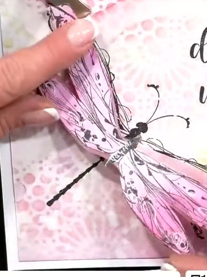 Step 7: Fold the dragonfly wings in half to create dimension. Position the folded dragonfly on your card and attach it