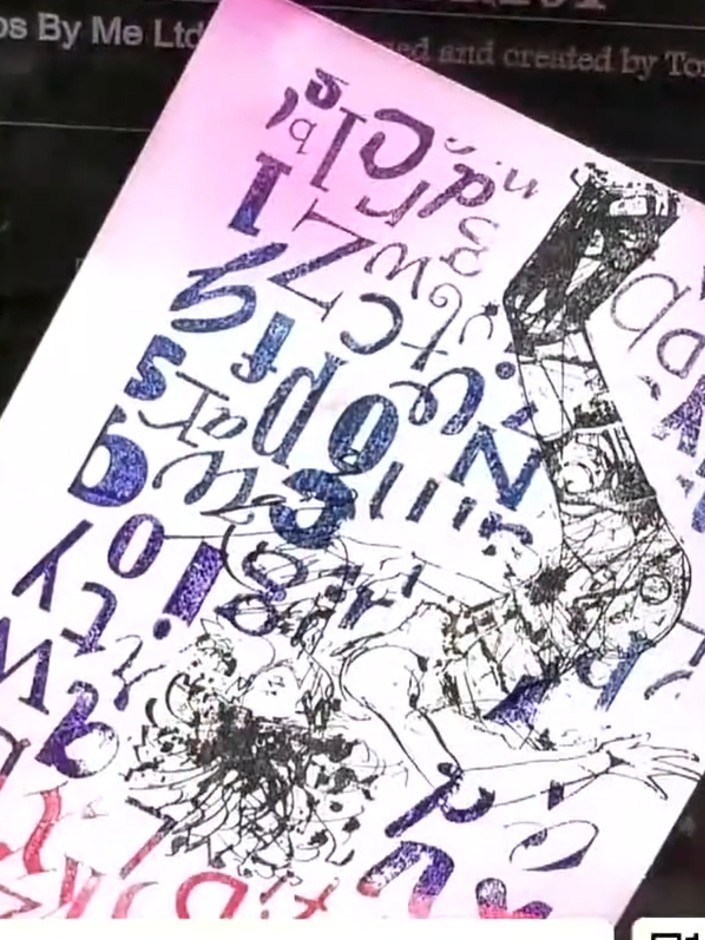 Step 7: Add additional stamped details around the character using the alphabet and text stamps from the set. Stamp ran