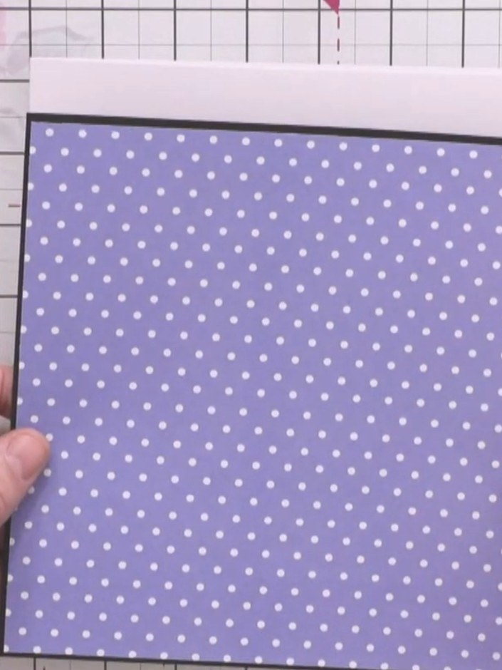 Step 1: Take your 8 by 8 inch card blank and adhere a black mount to the front. Then attach a purple polka dot card pa