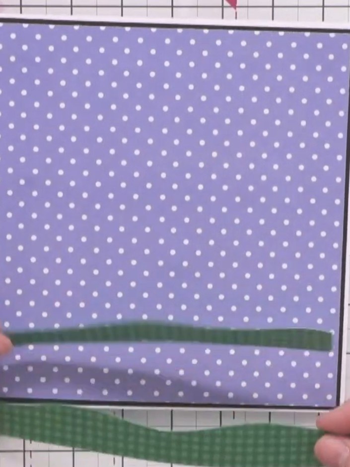 Step 2: Cut a strip of green gingham card and draw a wobbly grass line across it freehand. Glue this strip to the bott