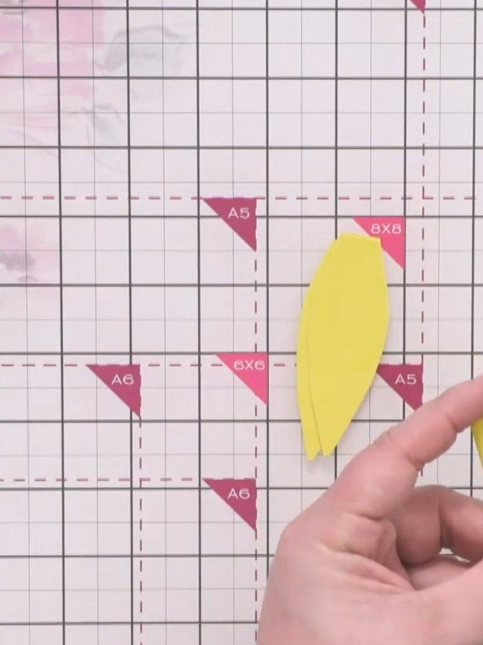 Step 4: Freehand cut petal shapes from the folded yellow card, starting at the bottom and cutting up to the top to cre