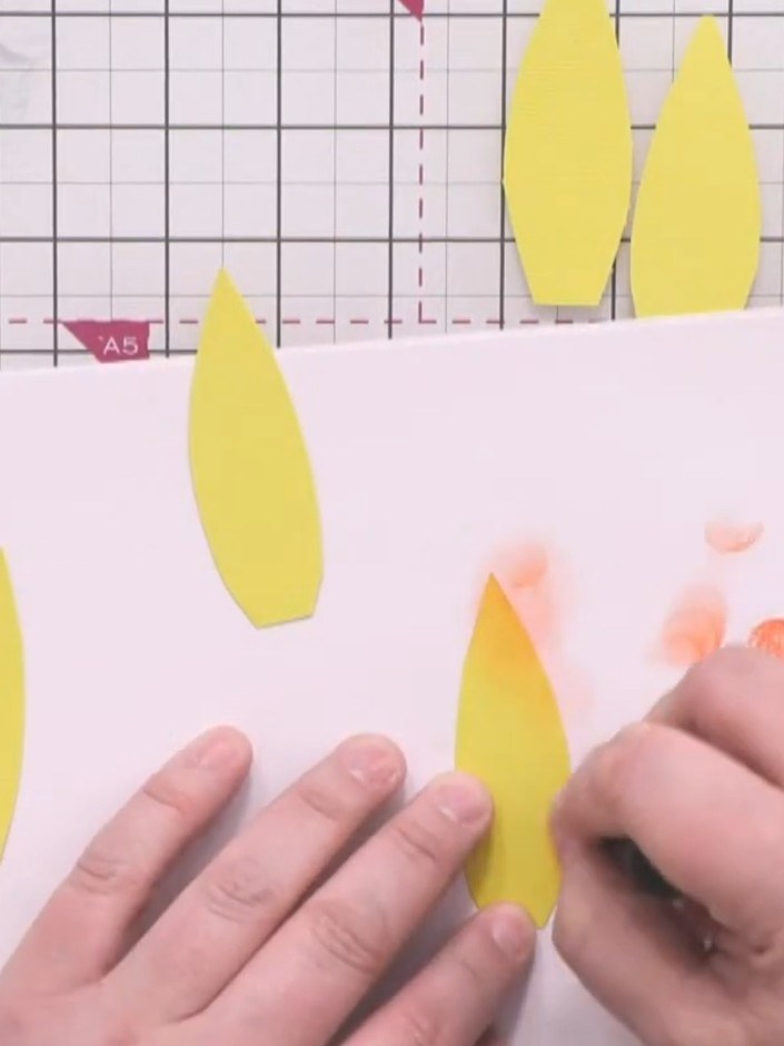 Step 5: Using a small blending brush, apply bittersweet orange ink to each yellow petal. Concentrate more colour towar