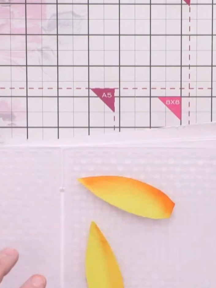 Step 6: Run the inked yellow and orange petals through your embossing machine using the retro spots embossing folder t