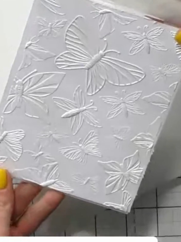 Step 6: Using a blending brush, add additional colours to different areas of the embossed butterfly design to create m