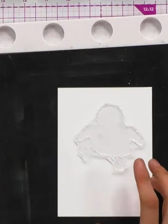 Step 2: Position the solid portion of the spring blossom stamp in the centre of the white card panel. Ensure the duckl