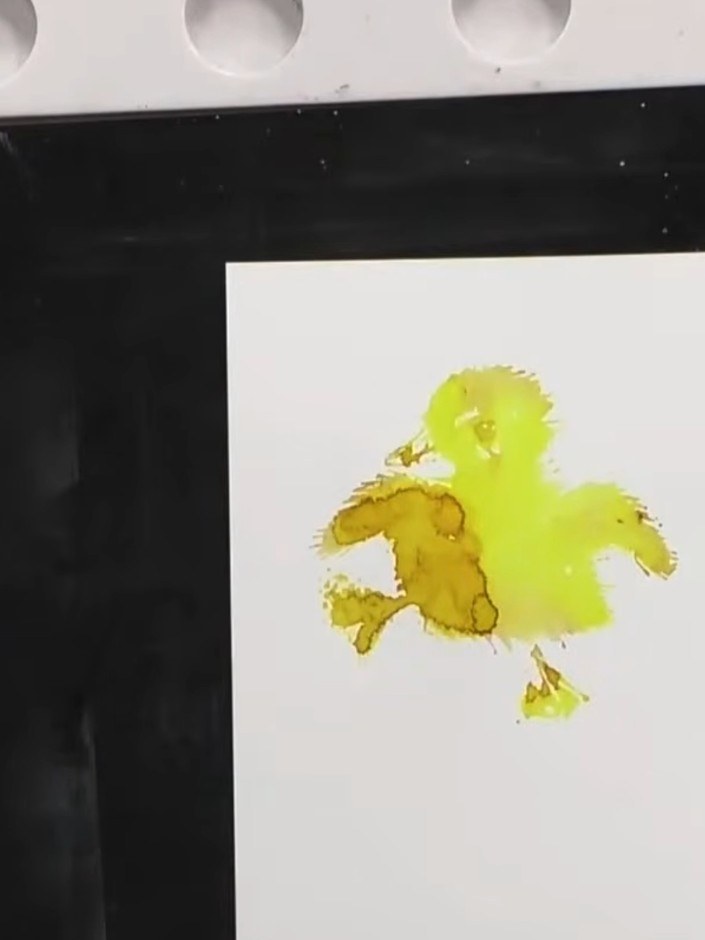 Step 9: Stamp the detail portion of the duckling stamp over the dried yellow watercolour to add feather definition and