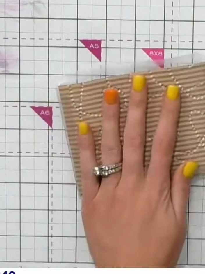 Step 9: Peel off the second side of the pre-applied tape from the acetate window. Fold the corrugated cardstock panel 