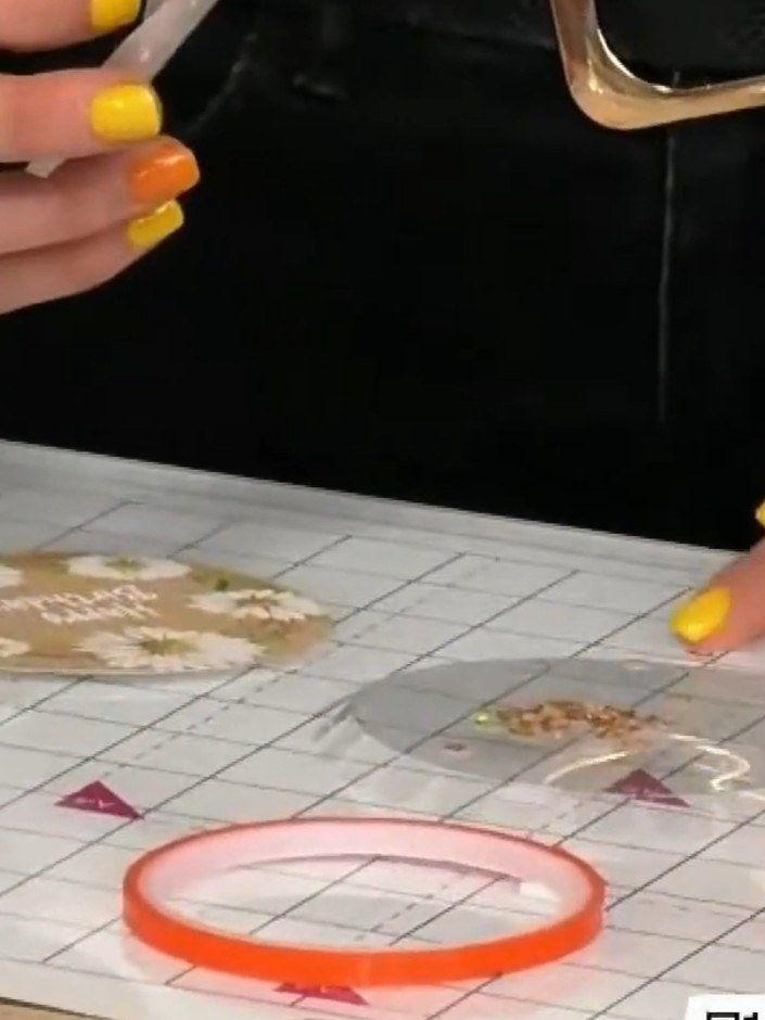 Step 9: Fold each tooth of the adhesive tape around the edge of the circle one at a time, working your way around the 