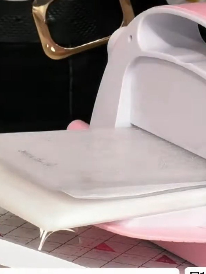 Step 2: Apply white ink directly to the embossing folder using a white ink pad, ensuring even coverage across the rais