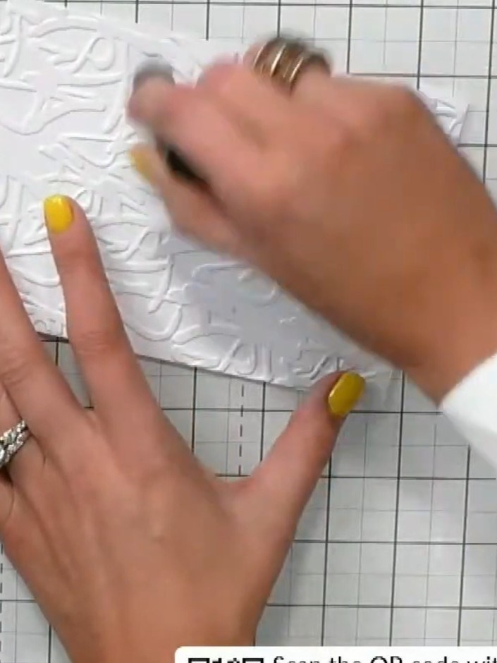 Step 6: Continue adding additional ink colours to the embossed panel, layering them over the existing colours for visu