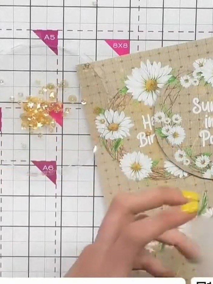 Step 5: Place the shaker embellishments inside the circular window on the card. Add the decorative elements before sea