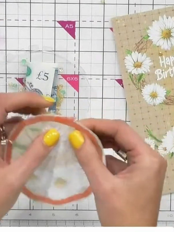 Step 6: Insert a five pound note or gift card into the back of the circular shaker window, positioning it so it will b