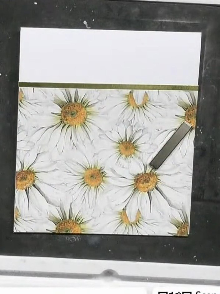 Step 2: Glue the patterned paper with the daisy design to the base of a white card blank. Position it centrally on the
