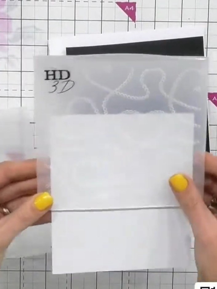 Step 2: Place your white card inside the HD 3D embossing folder with the heart design. Run the folder through your die