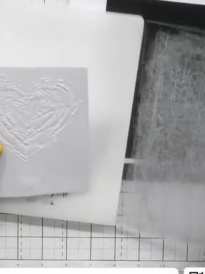Step 3: Carefully open the embossing folder and remove the embossed white cardstock. The heart design should now be ra