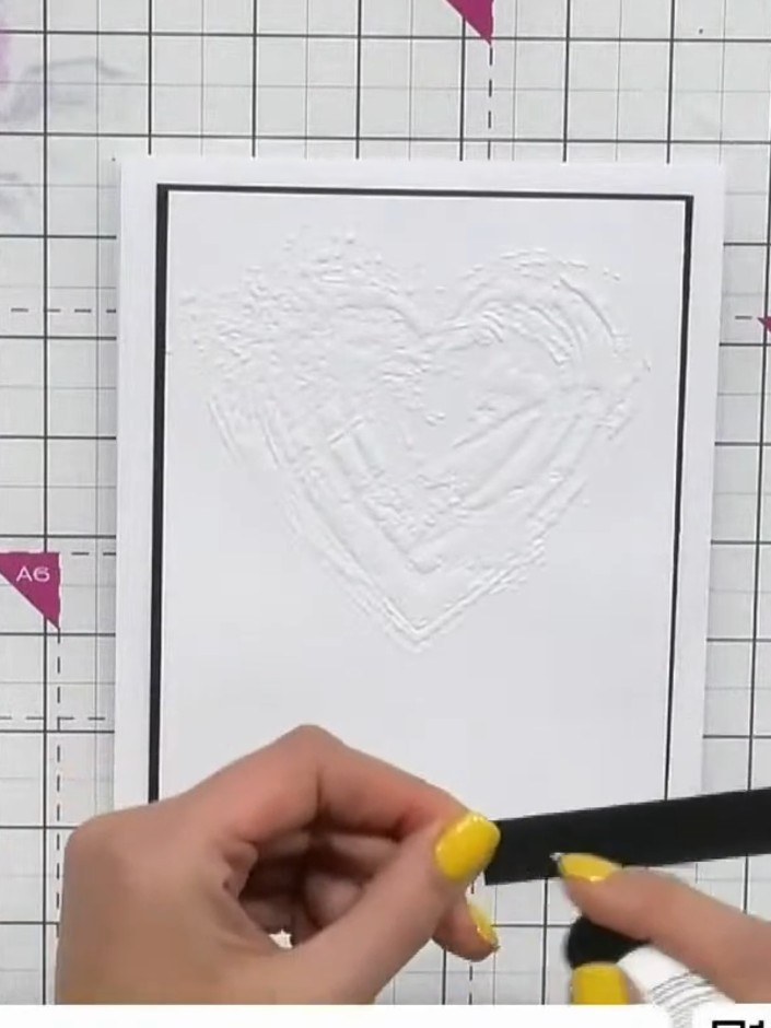 Step 6: Add a black banner strip of cardstock horizontally across the embossed card front to soften the visual break c