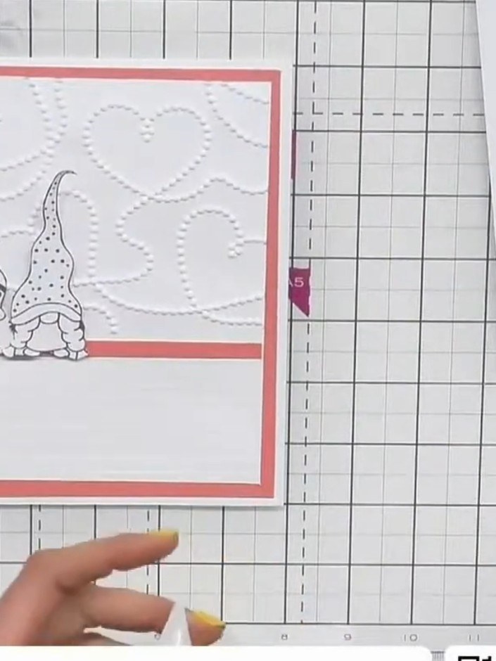 Step 7: Add a small ribbon bow or decorative embellishment to the centre of the card where the two gnomes meet to tie 