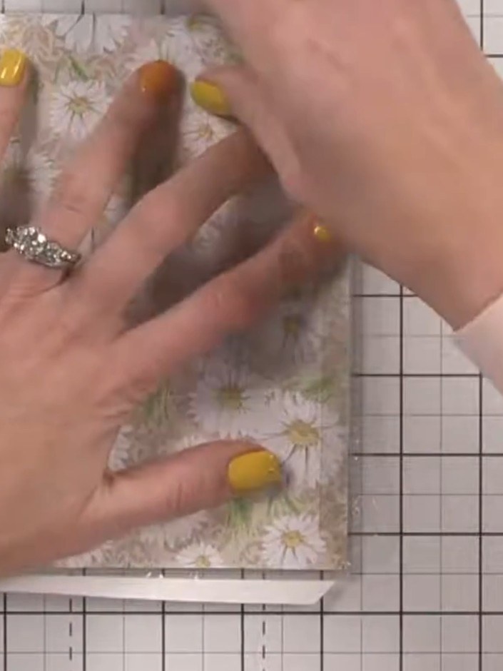 Step 8: Fold down the first side of the acetate window and press firmly with your fingers. The tape grips immediately,
