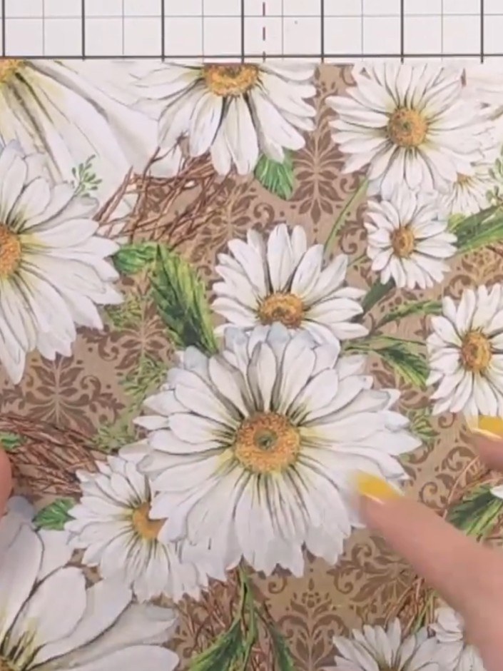 Step 1: Cut one piece of patterned paper from your 8 by 8 inch pad to measure 6 by 8 inches using your trimmer or guil