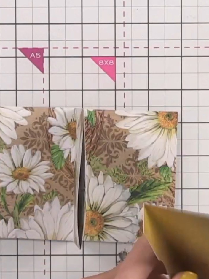Step 10: Apply adhesive to the left, bottom and right edges of the first hinged page. Attach it to the front cover, lea