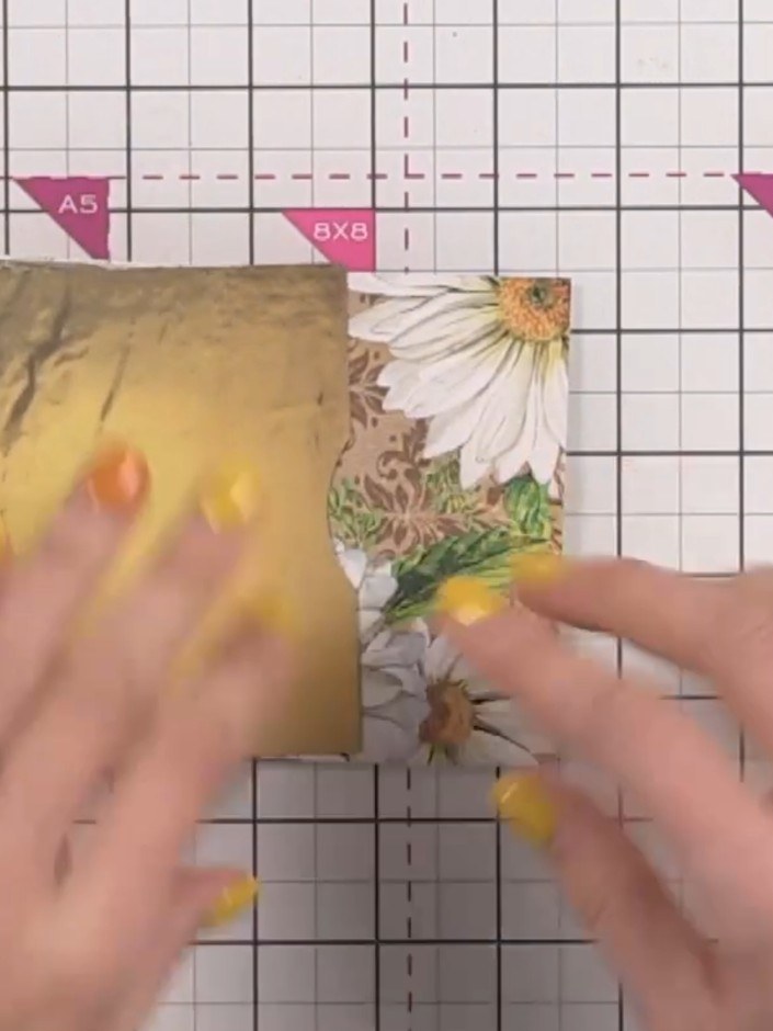 Step 11: Attach the second hinged page to the back cover using double-sided tape along the gold spine edge, creating an