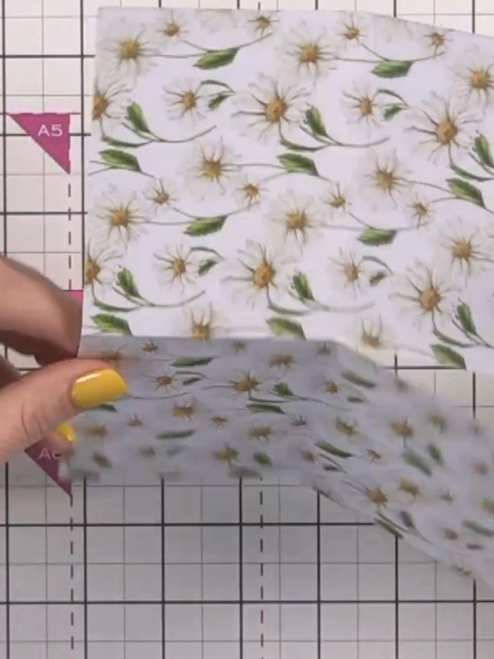 Step 5: Fold the scored paper so the cut sections overlap, creating a pocket in the centre. The floral design should b