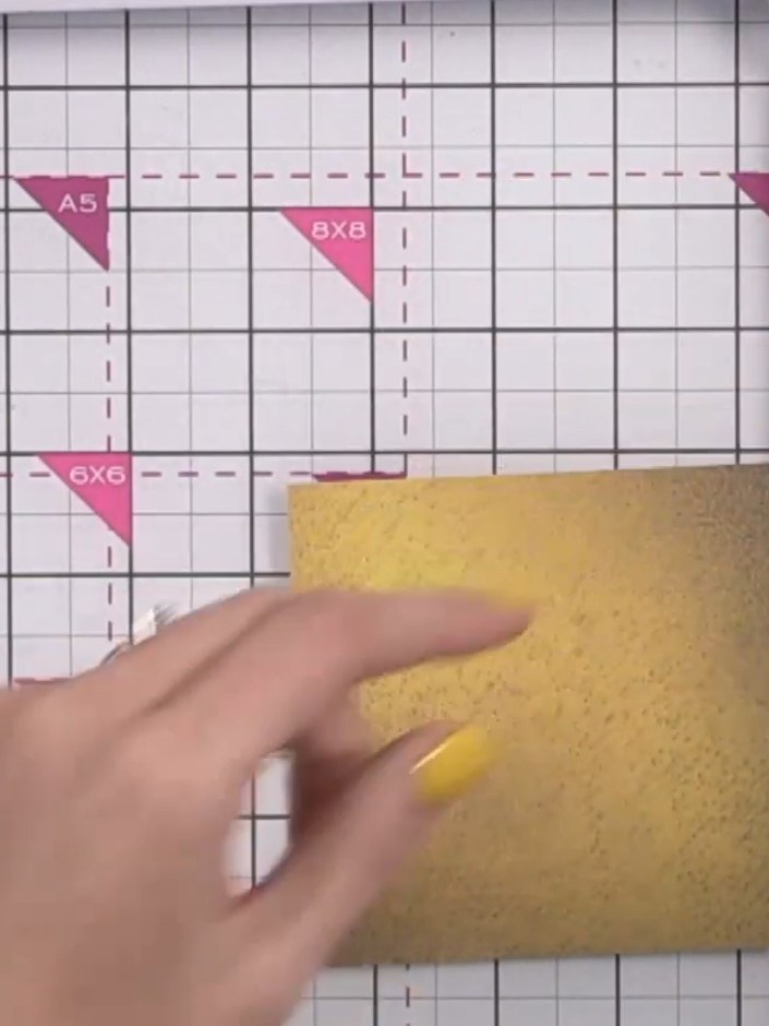 Step 8: Score each 4 x 4 inch square at 1 inch on all four sides using your scoreboard. This will create hinged pages 