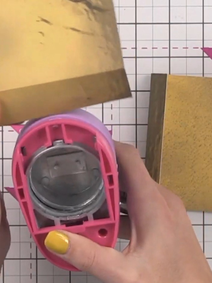 Step 9: Using a circular punch, make a hole near the fold line of the hinge to indicate there is a pocket behind. This