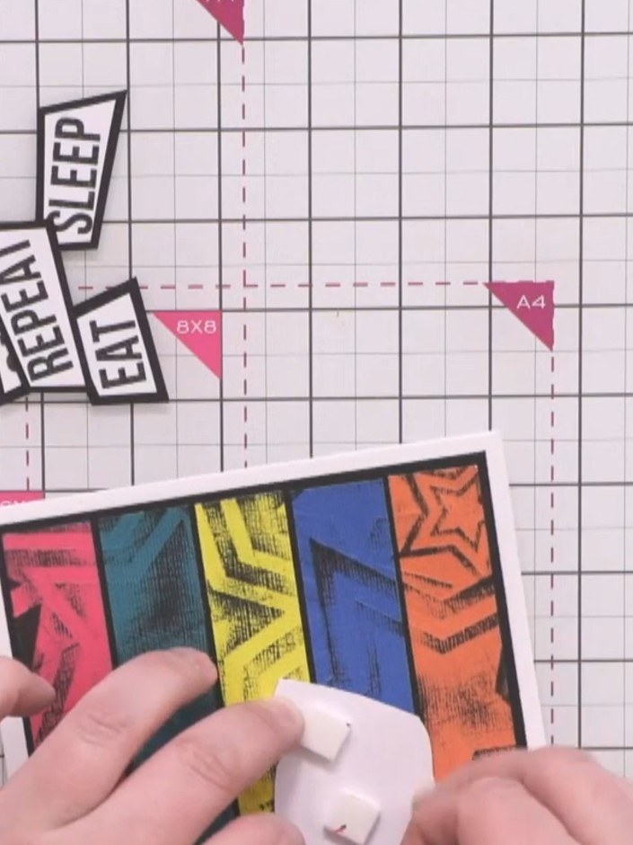 Step 14: Attach the colourful striped character panel to the bottom right corner of the card front using foam pads to a
