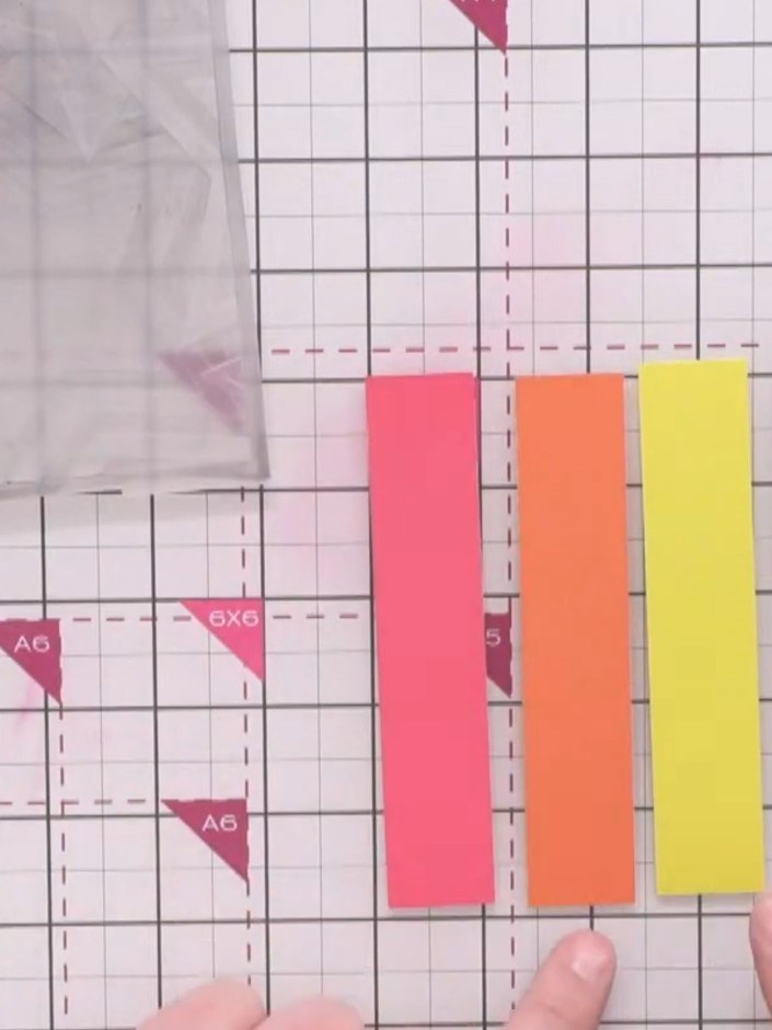 Step 2: Arrange the coloured card strips in order from light to dark tones, alternating the colours to create visual v