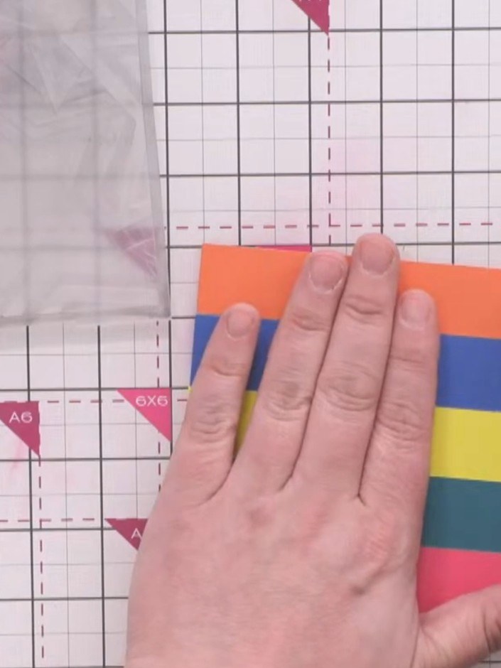 Step 3: Line up all five coloured strips at the bottom edge. Hold them in position and secure them together with low-t