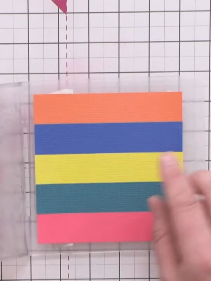 Step 5: Run the striped cardstock panel through your embossing machine with the star cluster embossing folder to creat
