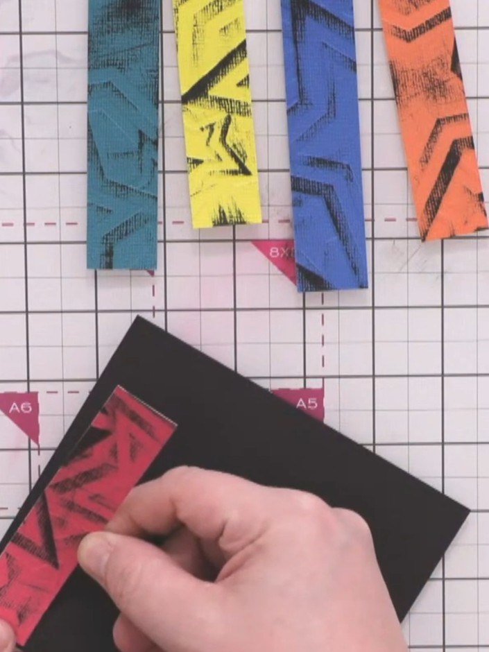 Step 8: Glue the embossed strips onto a black card background, arranging them to create a continuous striped design. P