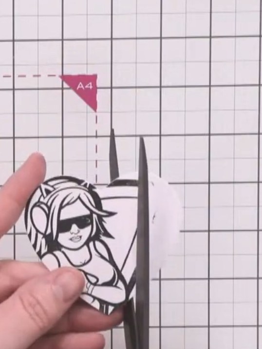 Step 12: Carefully cut out the character stamp image using scissors, ensuring her head aligns with the top of the heart