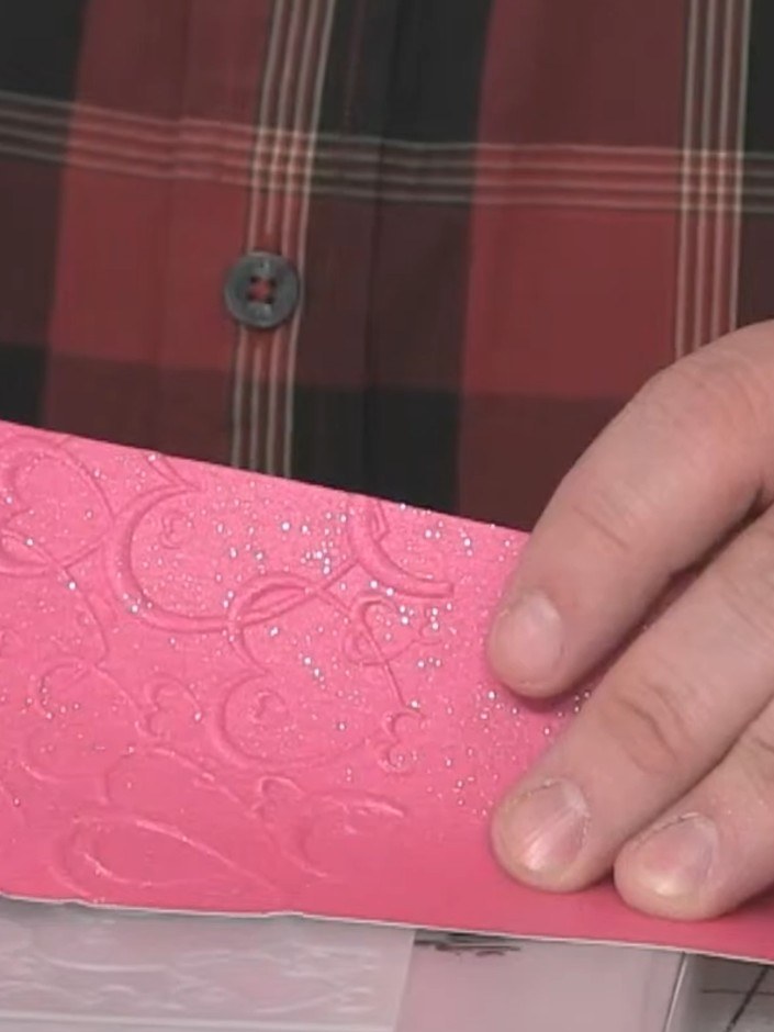 Step 2: Run the embossing folder with the love hearts design through your die-cutting and embossing machine to create 