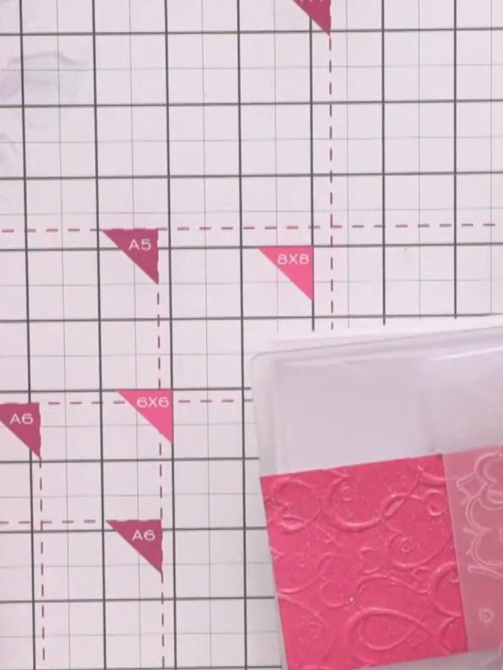 Step 3: Feed the embossed pink cardstock back through the embossing folder, positioning it so the heart pattern contin