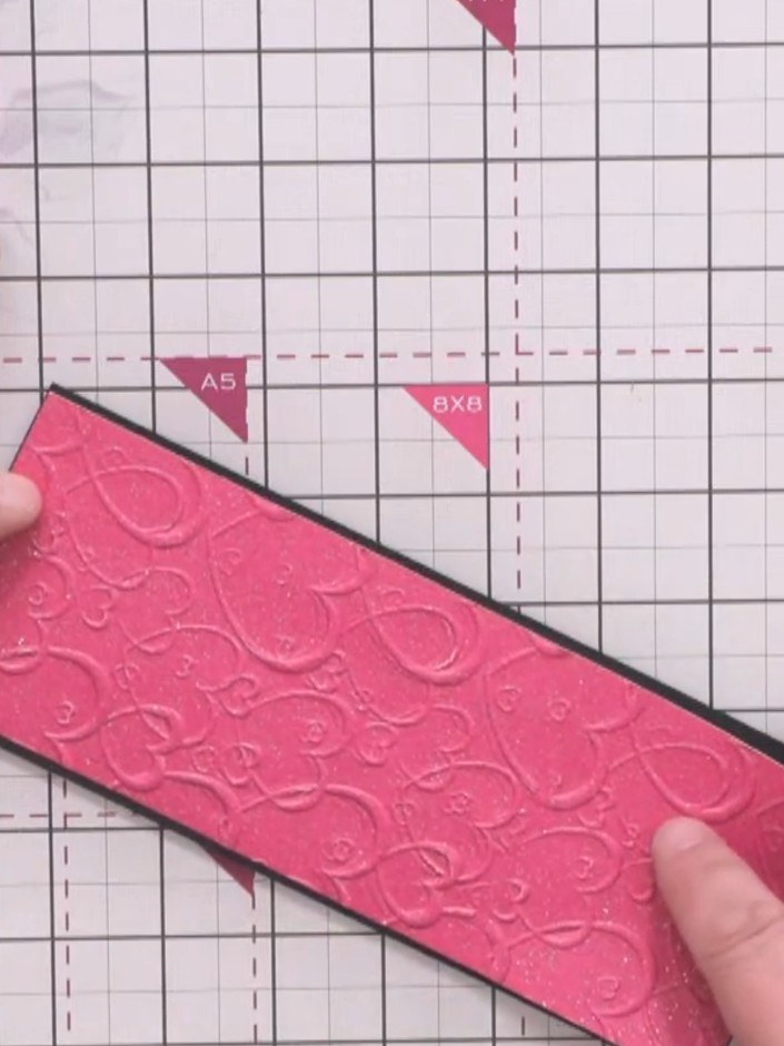Step 5: Mount the embossed pink panel onto black cardstock to create a border frame. This will add contrast and defini