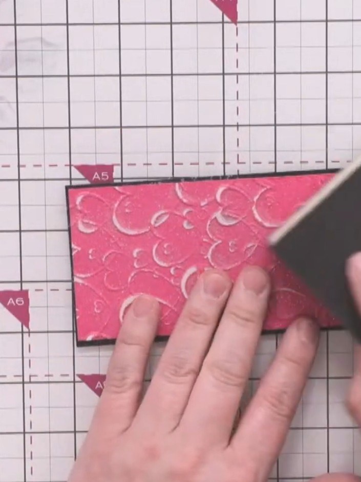 Step 6: Using a decorative sanding sponge, gently sand the tops of the raised hearts with circular motions to create a