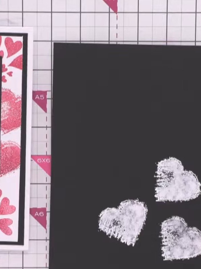 Step 1: Stamp the heart design from the Stamps By Me A4 Enjoy Today stamp set using white ink onto black card. Create 