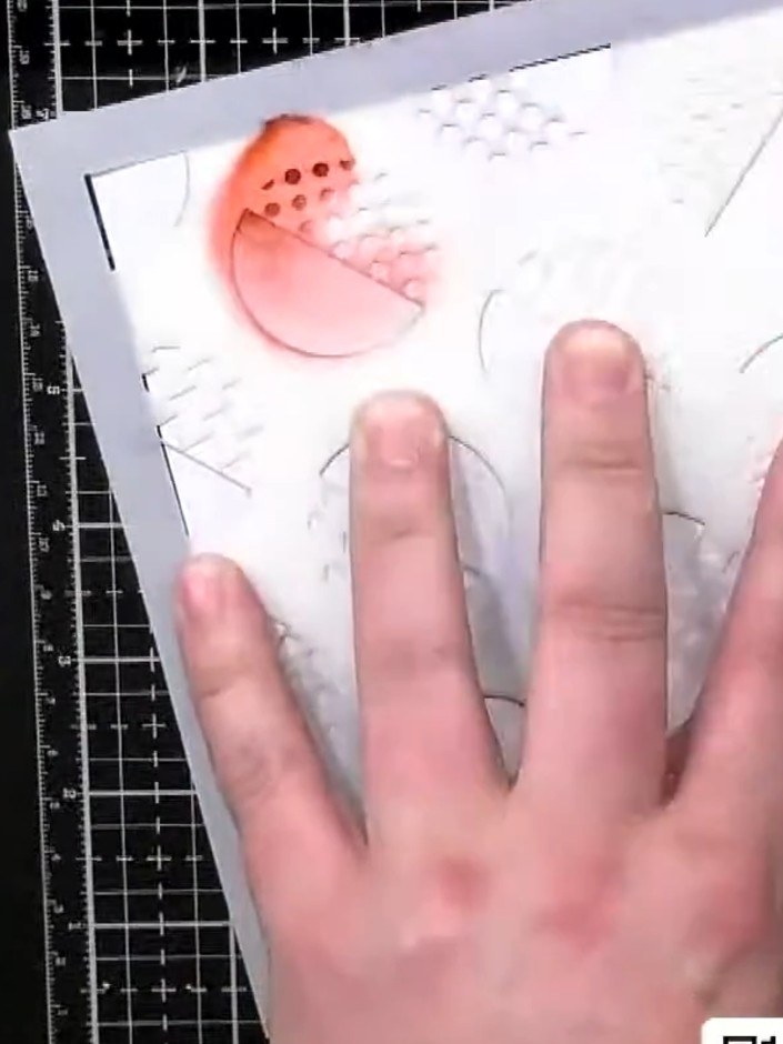 Step 1: Position the retro dots stencil on the front of your prepared card blank. Hold it in place with your hand to p